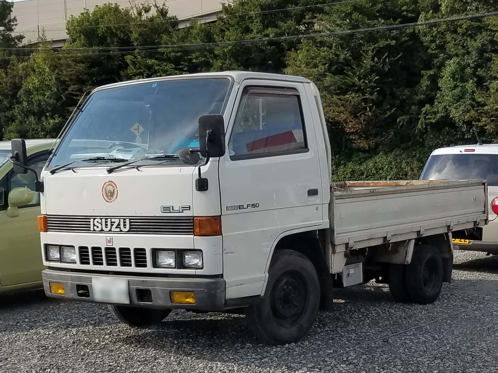 Isuzu Elf Flatbed Truck Parked Wallpaper