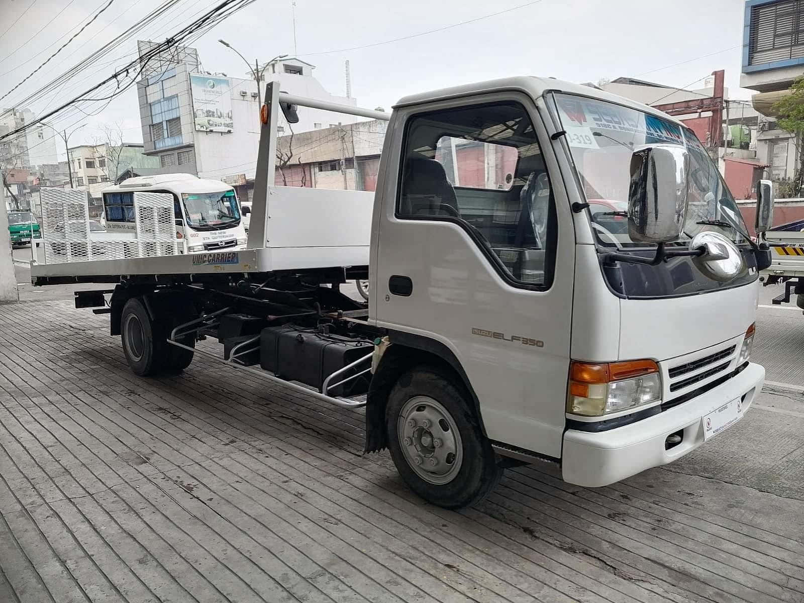 Isuzu Elf Flatbed Truck Parkedon Street Wallpaper