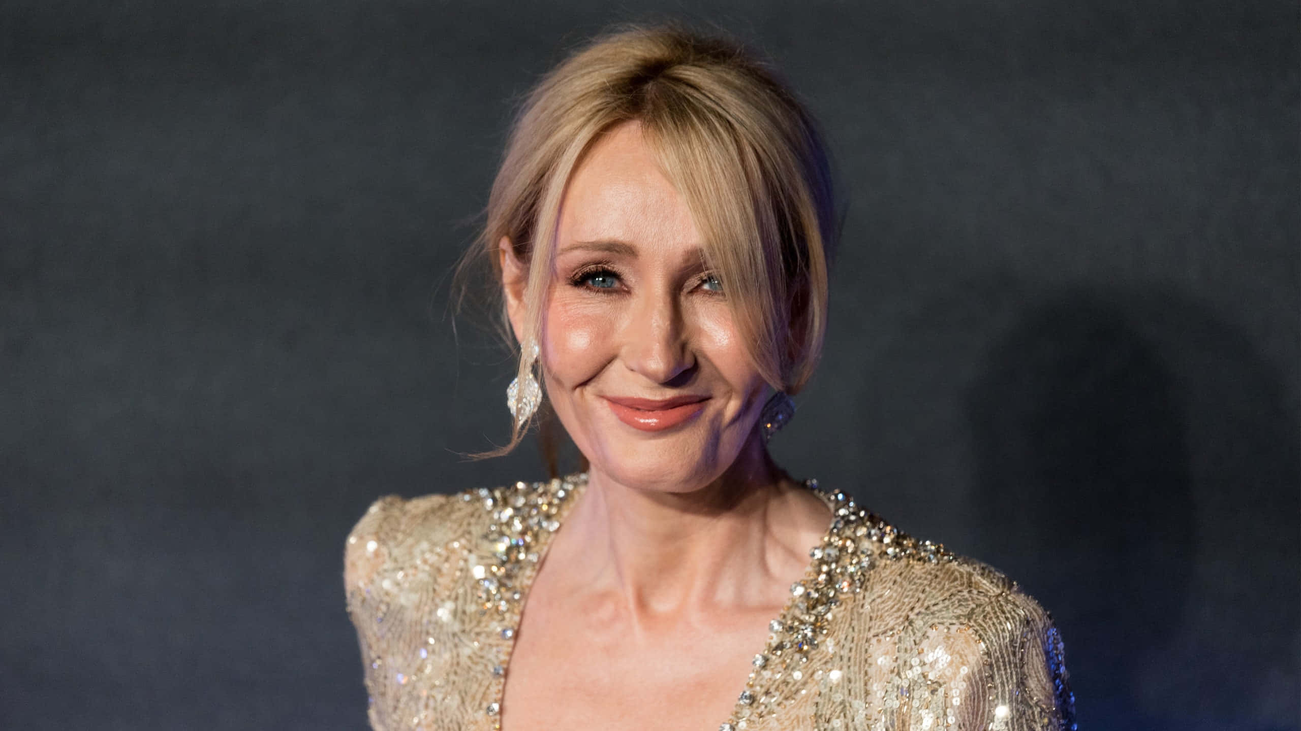 J.k. Rowling Smiling At A Book Event Wallpaper