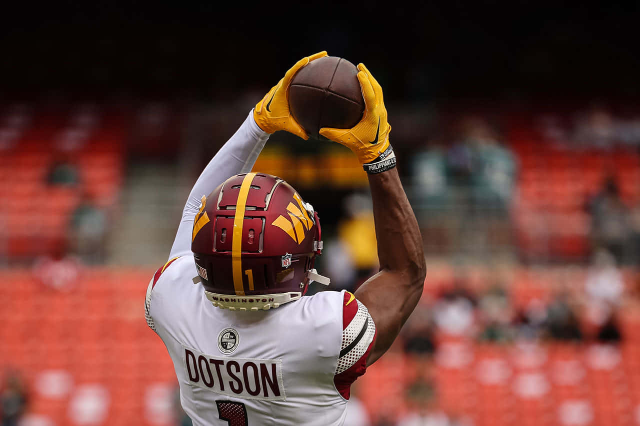 Jahan Dotson Catching Football During Game Wallpaper