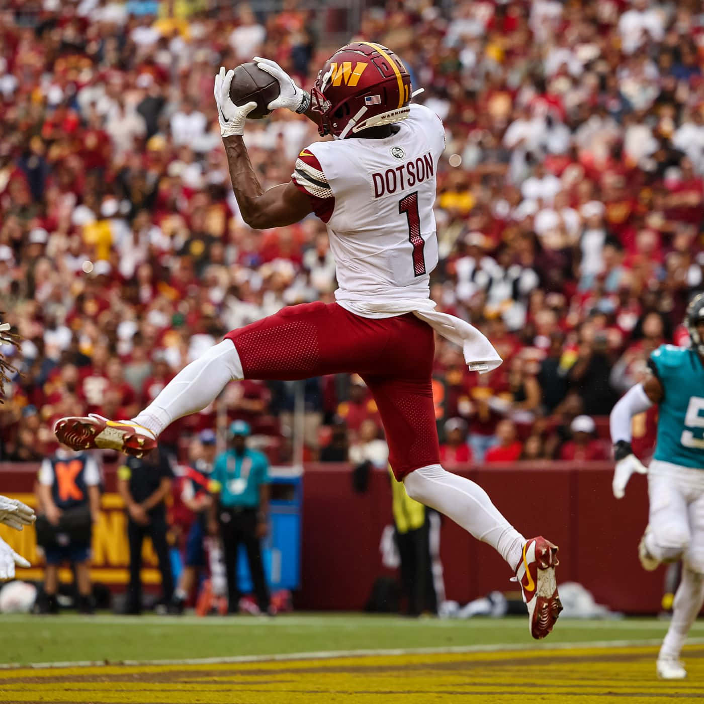 Jahan Dotson Catching Football In Midair Wallpaper