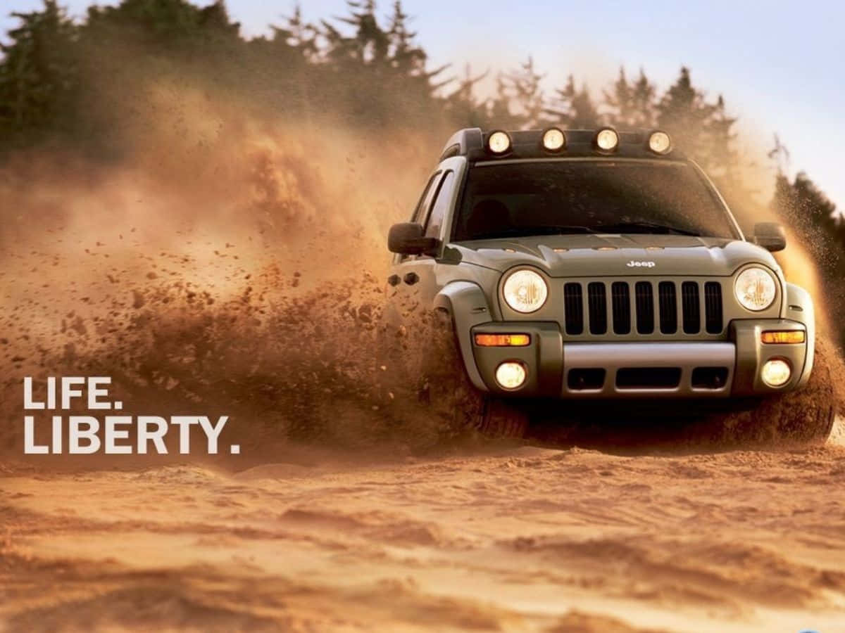 Jeep Liberty Cruising Through A Scenic Landscape Wallpaper