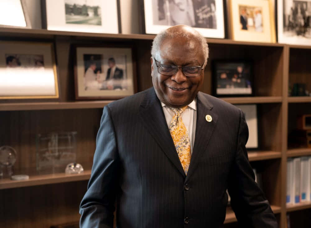 Jim Clyburn With Shelf Of Photos Wallpaper