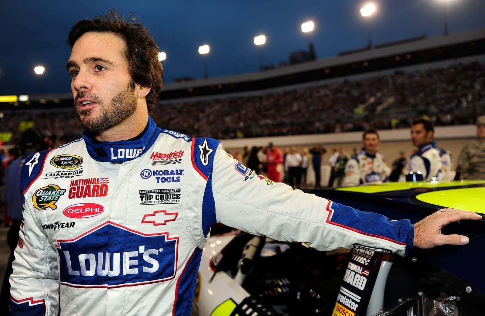 Jimmie Johnson Posing With His Nascar Stock Car Wallpaper