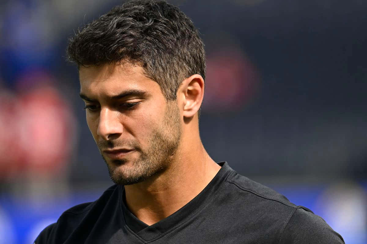 Jimmy Garoppolo Striking A Pose On The Football Field Wallpaper