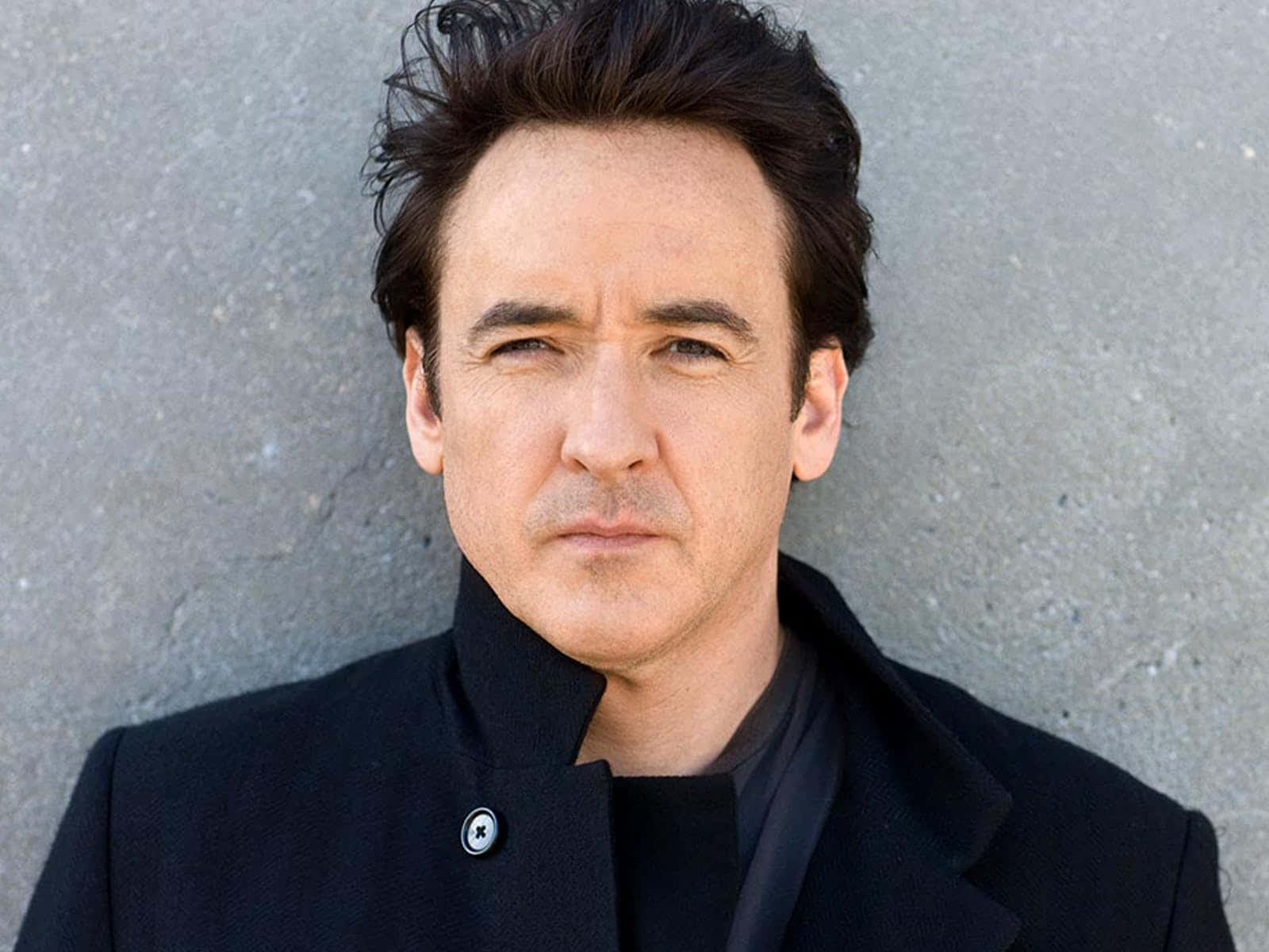 John Cusack Posing With A Confident Smile Wallpaper