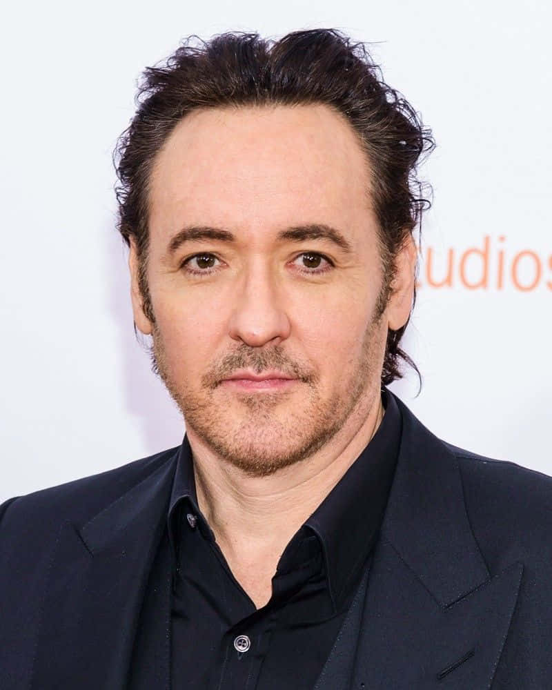 John Cusack Smiling In A Portrait Wallpaper