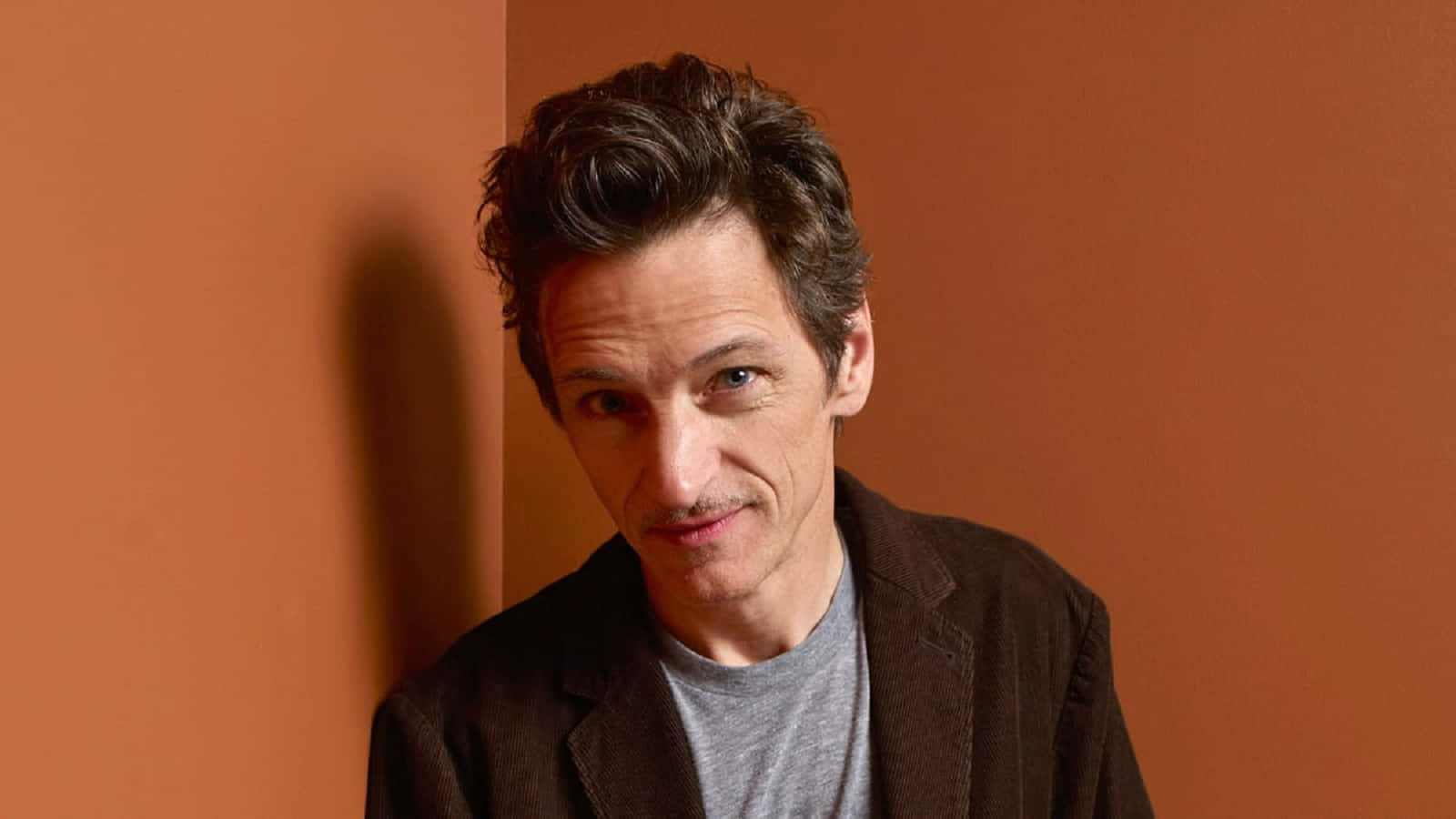 John Hawkes Posing For A Photo Shoot Wallpaper