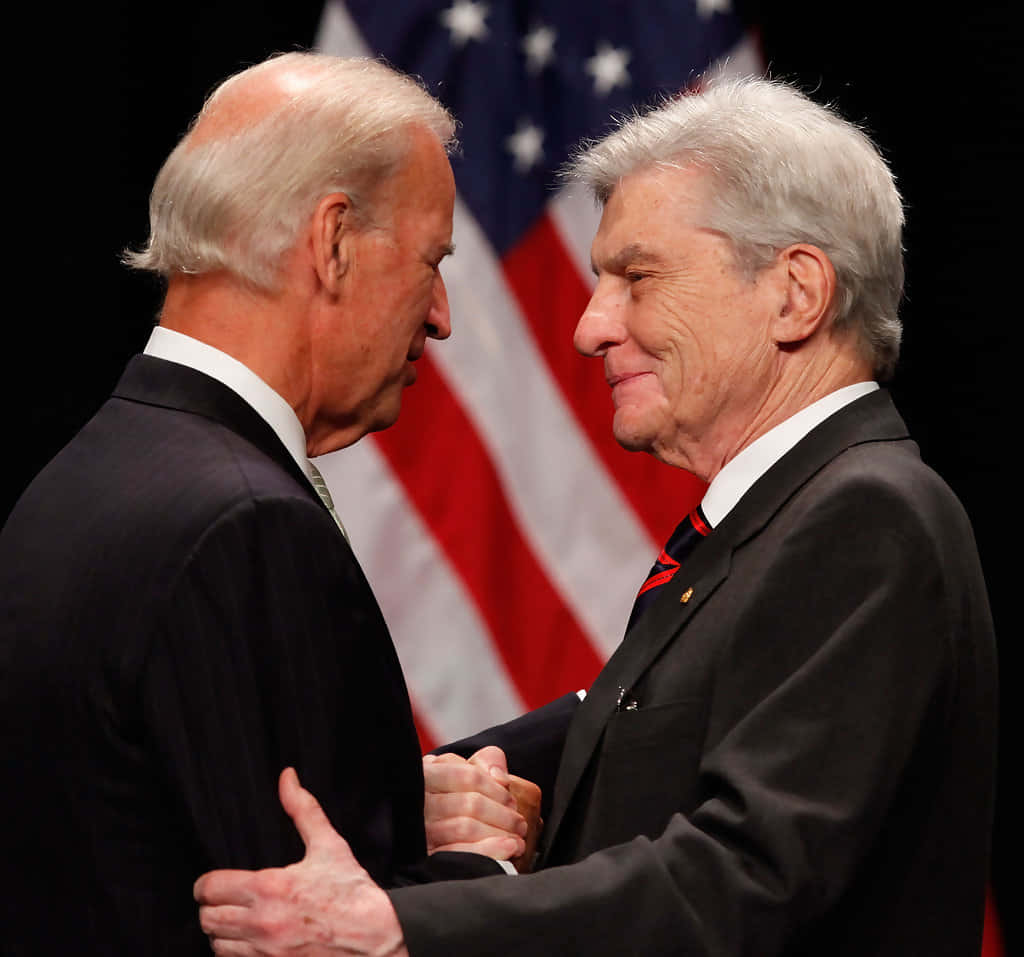 John Warner And Joe Biden With American Flag Wallpaper