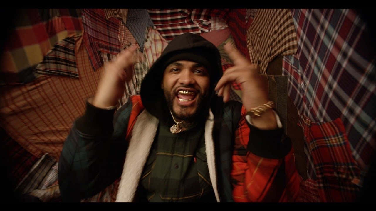 Joyner Lucas Embodies Suave Hip-hop Style In This Iconic Portrait Wallpaper