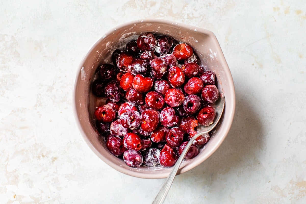 Juicy Red Cherries Against Vibrant Background Wallpaper