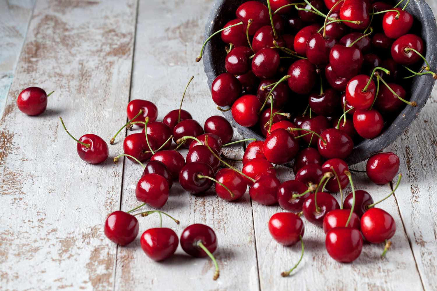 Juicy Red Cherries On Wooden Table Wallpaper