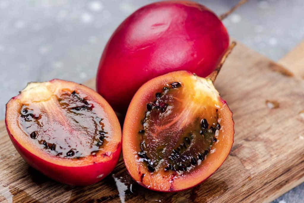 Juicy Red Fruit On A Wooden Table Wallpaper