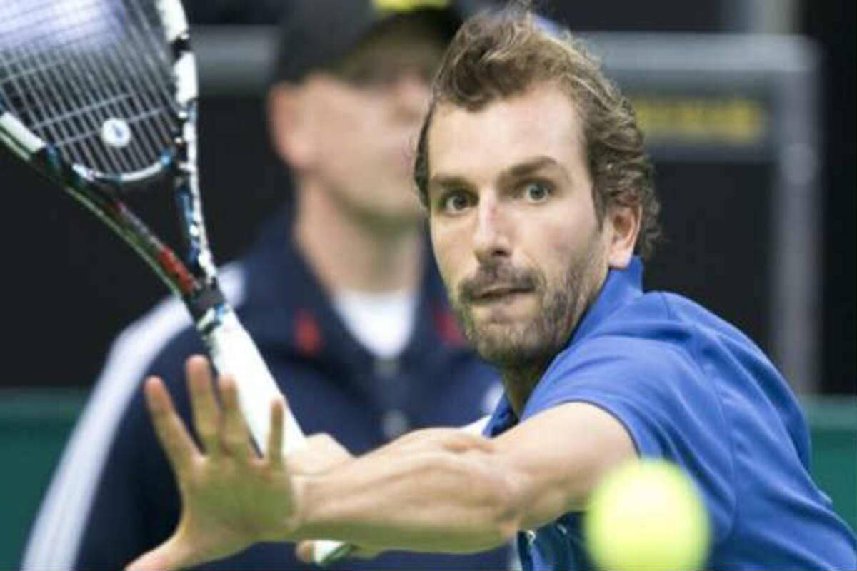 Julien Benneteau Attired In Royal Blue Polo On Court Wallpaper