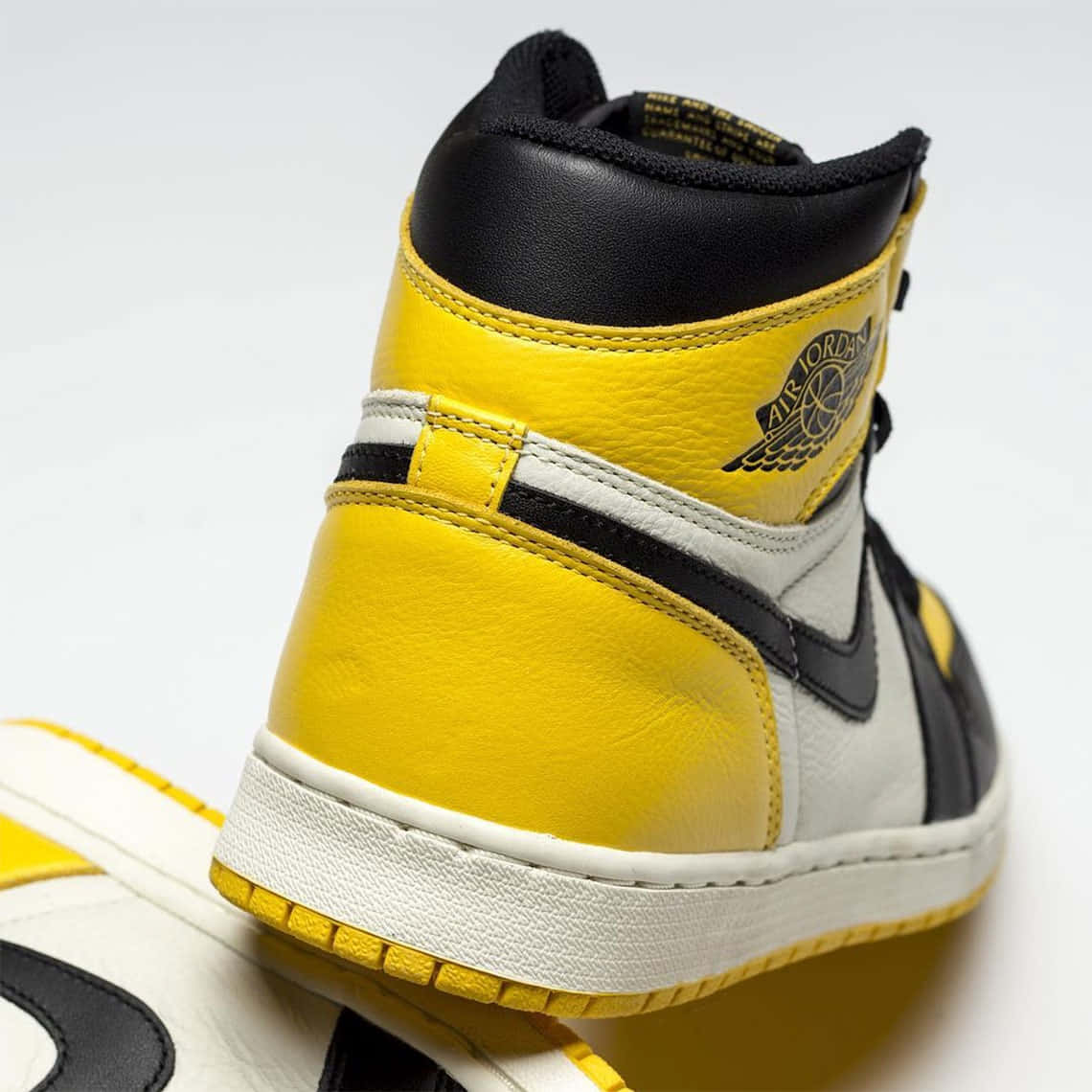 Jump Into Style With This Signature Yellow Jordan Footwear! Wallpaper