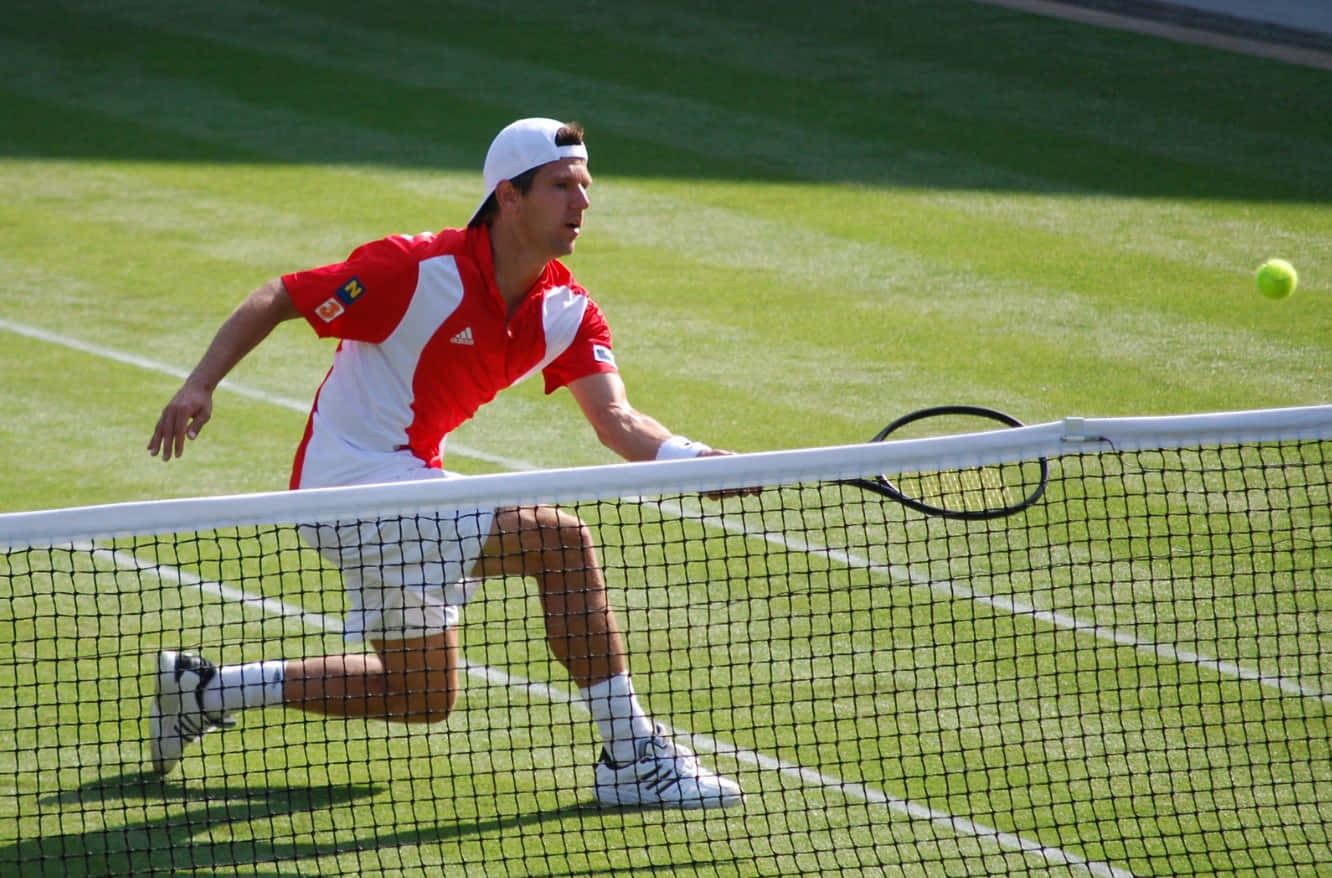 Jurgen Melzer In Action Donned In Red And White Tennis Attire Wallpaper