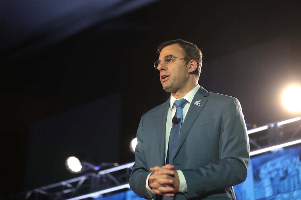 Justin Amash Standing In A Stadium Wallpaper