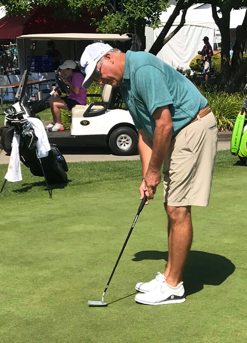 Ken Duke, Pga Tour Winner, Casting A Shadow On The Golf Course. Wallpaper