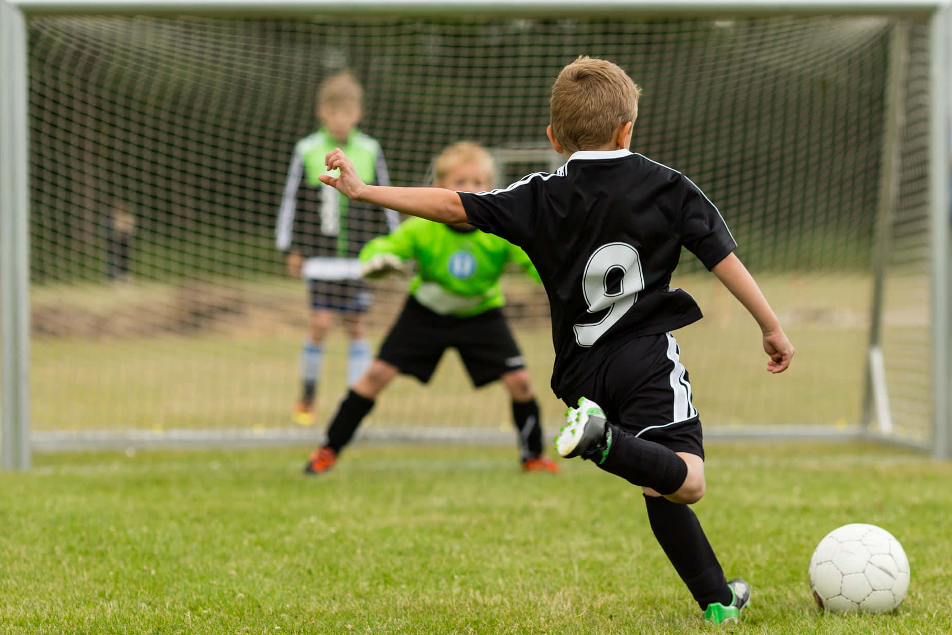 Kids Enjoying Soccer In The Field Wallpaper