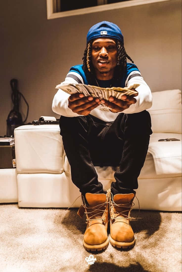 King Von Showing Money Indoors Wallpaper