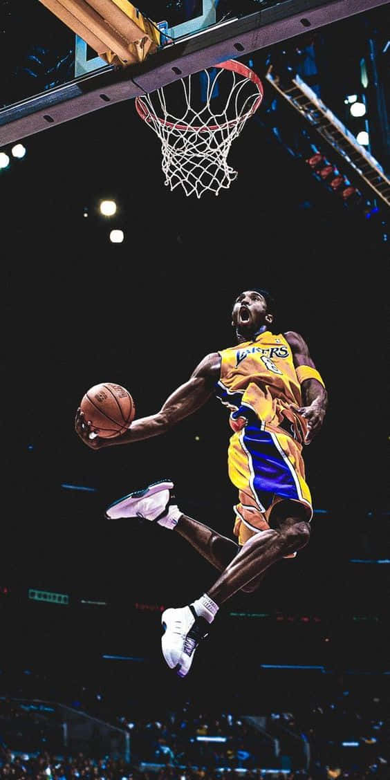 Kobe Bryant Flying Through The Air With Fierce Determination Wallpaper