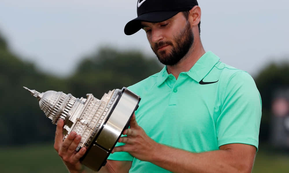 Kyle Stanley Looking At His Golf Trophy Wallpaper