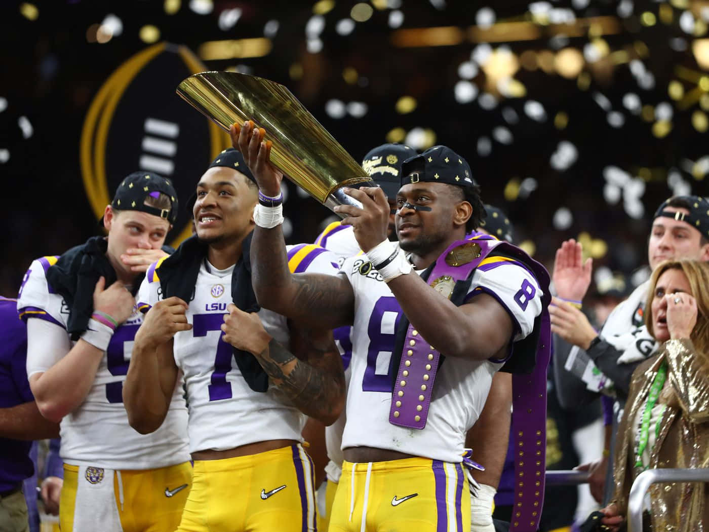 L S U Football Players Celebratingwith Trophy Wallpaper