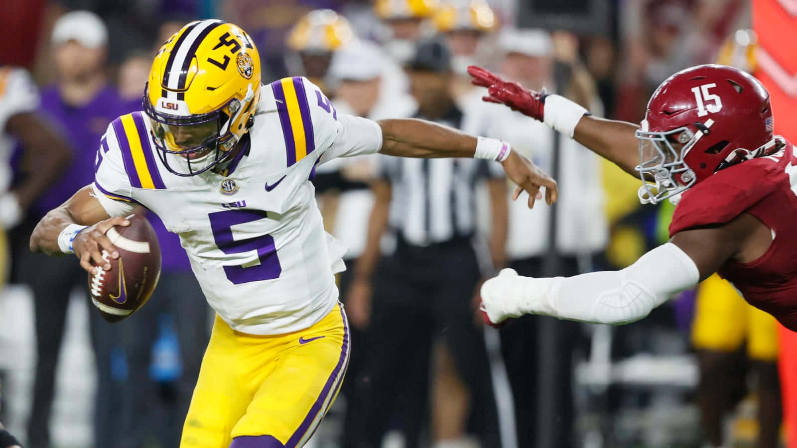 L S U Quarterback Evades Defender During Game Wallpaper