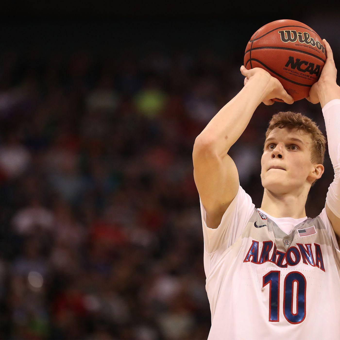 Lauri Markkanen In Action During A Basketball Game Wallpaper