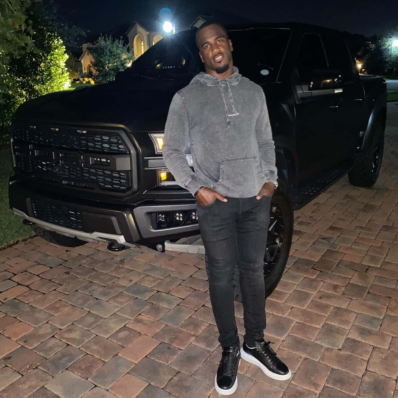 Lavonte David Standing Beside Truck Nighttime Wallpaper