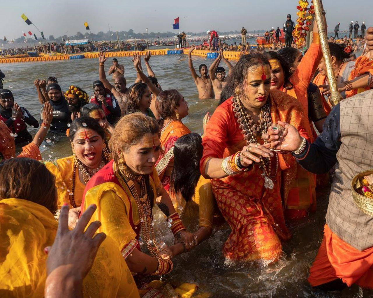 Laxmi Narayan Tripathi With Supporters Crossing Water Wallpaper