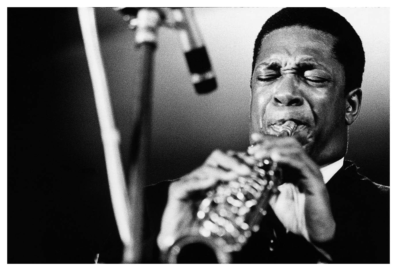 Legendary American Jazz Musician John Coltrane Playing Saxophone Wallpaper