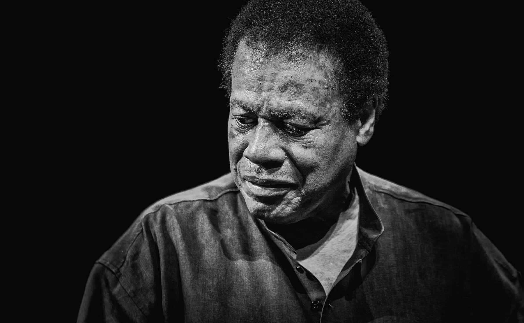 Legendary Jazz Musician Wayne Shorter Performing On Stage Wallpaper