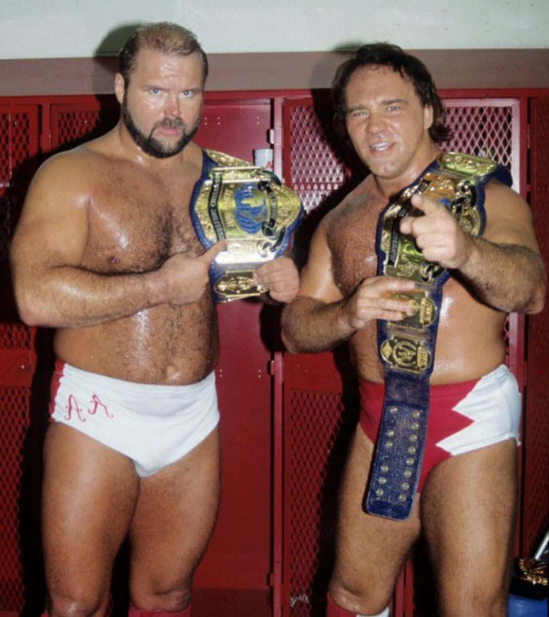 Legendary Wrestlers Larry Zbyszko And Arn Anderson Holding Championship Belts. Wallpaper