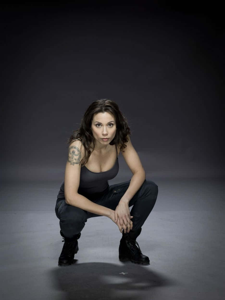 Lexa Doig Crouching Pose Wallpaper