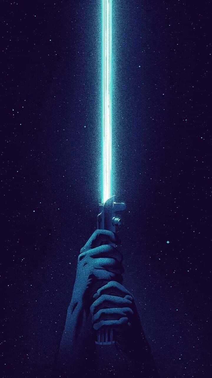 Lightsaber_ Raised_ Against_ Starry_ Sky Wallpaper