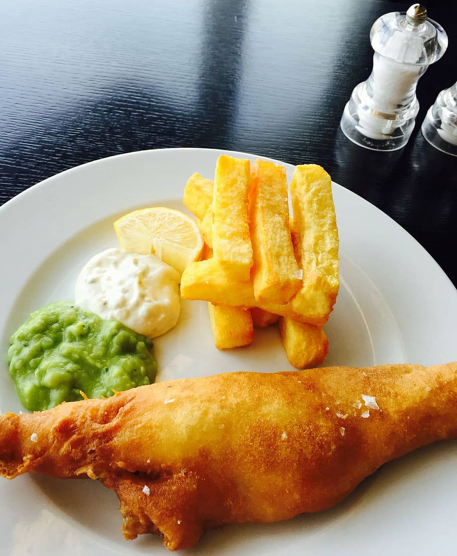 Lively Table With A Plate Of Fish And Chips Wallpaper