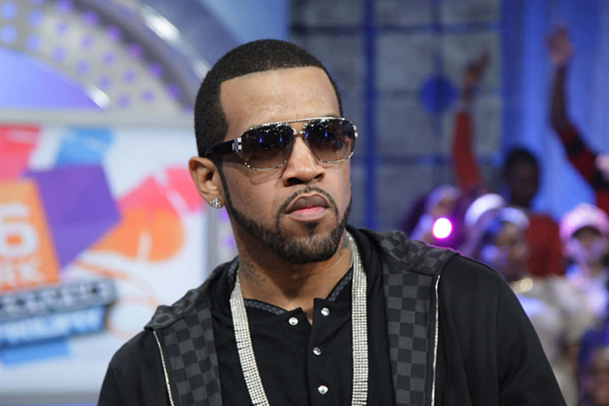 Lloyd Banks Sunglassesand Checkered Vest Wallpaper