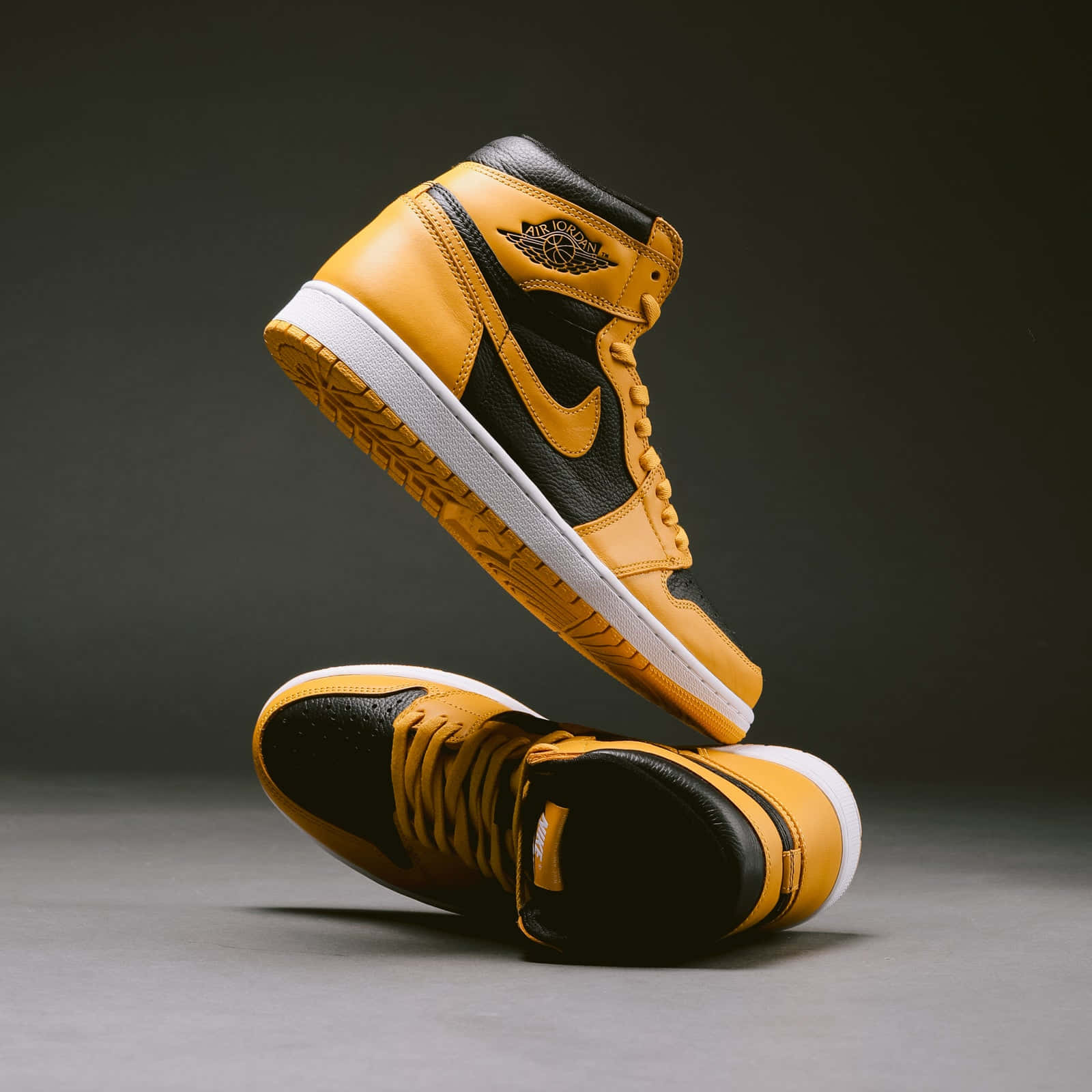 Look Stylish And Bold In The Classic Yellow Jordan Sneaker. Wallpaper