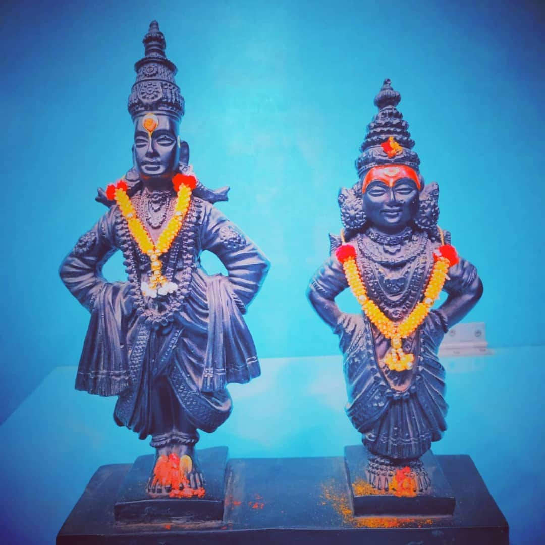 Lord Pandurang And Rukmini Statues With Garlands Wallpaper