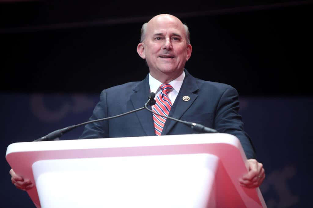 Louie Gohmert Holding Edges Of Podium Wallpaper