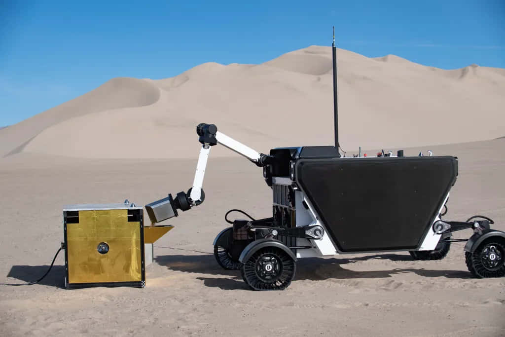 Lunar Rover Driving On The Surface Of The Moon Wallpaper