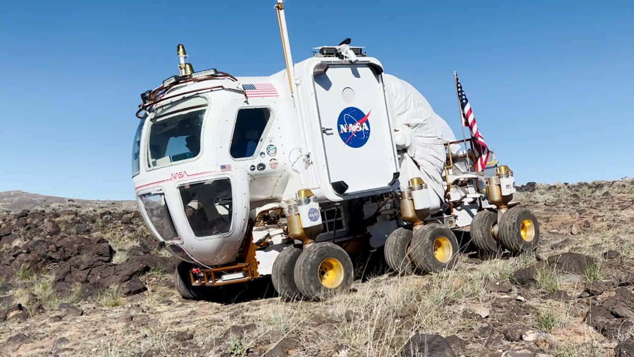 Lunar Rover Exploring The Moon's Surface Wallpaper