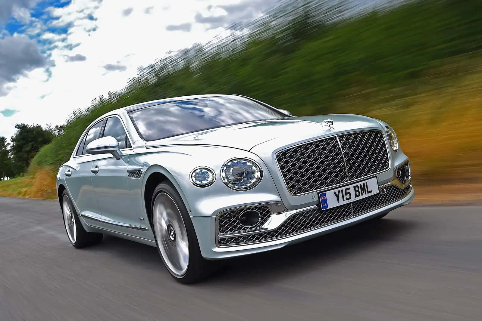 Luxurious Bentley Flying Spur Cruising On The Street Wallpaper