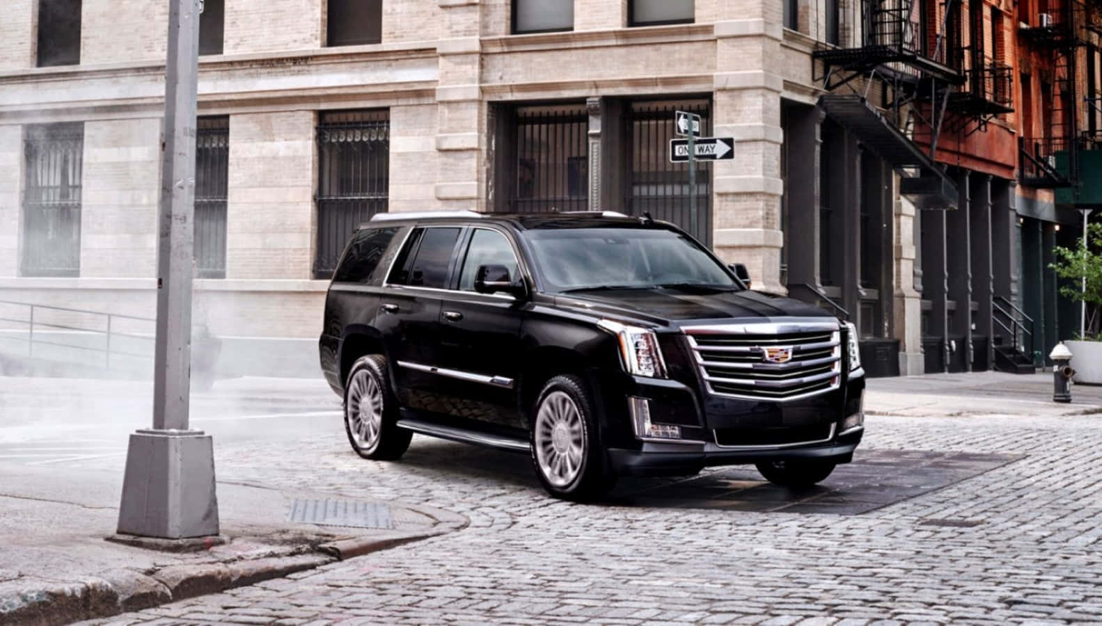 Luxurious Cadillac Escalade Cruising On A Scenic Path Wallpaper