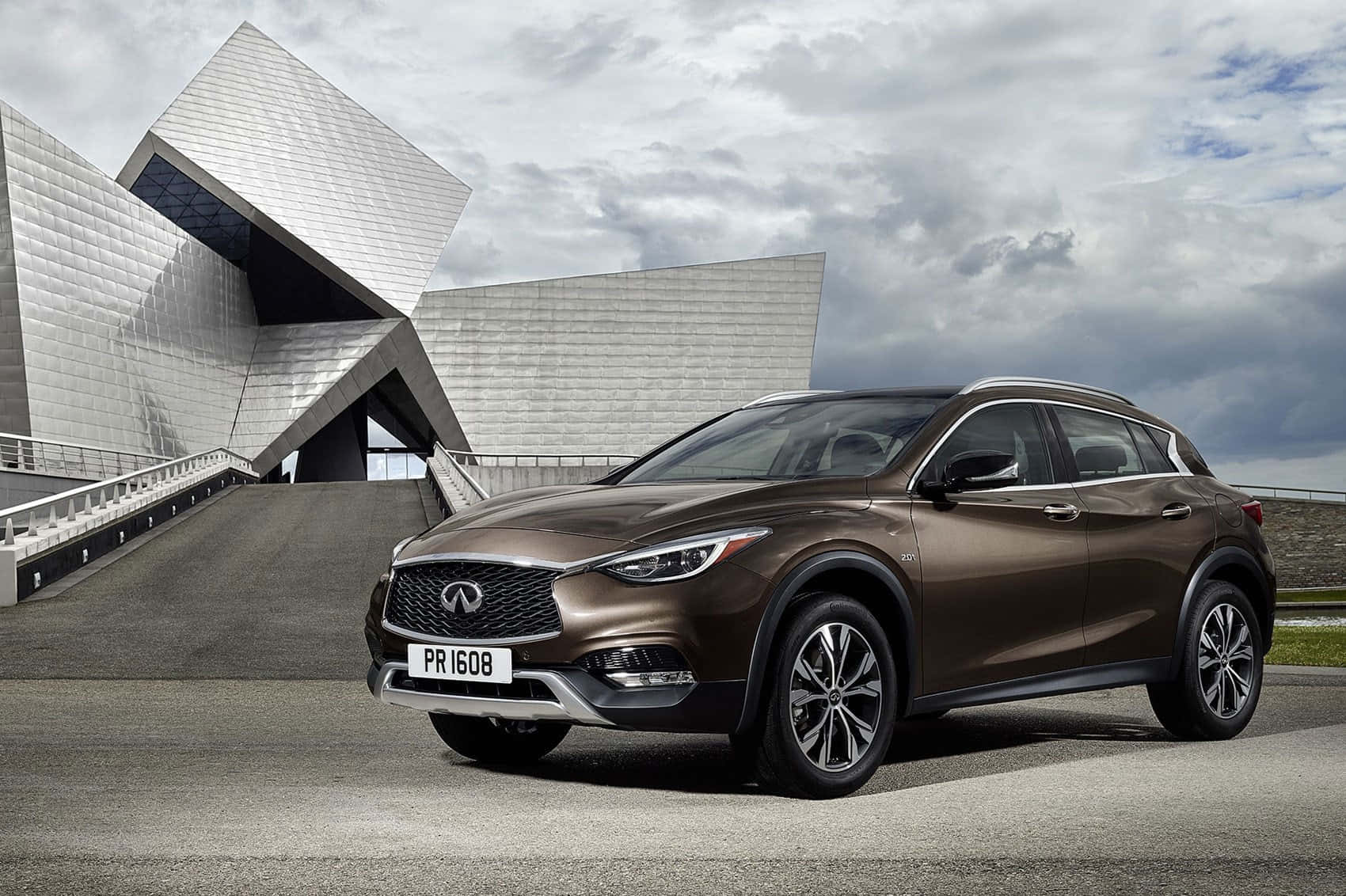 Luxurious Infiniti Qx30 Showcased Outdoors Against A Striking Sunset. Wallpaper