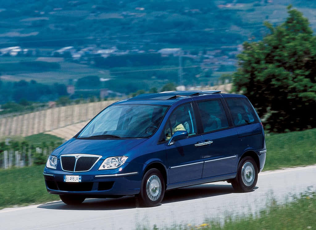 Luxurious Lancia Phedra Cruising On A Smooth Highway Wallpaper