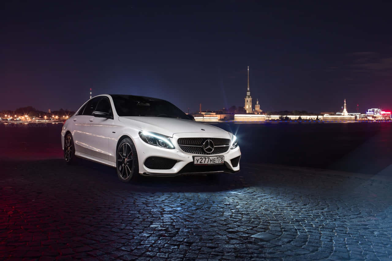 Luxurious Mercedes Benz C-class Amidst Scenic Landscape Wallpaper