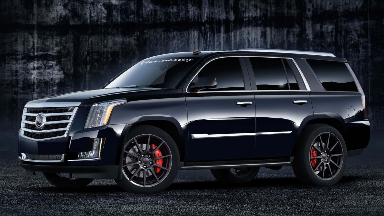 Luxury Cadillac Escalade Suv In Urban Setting Wallpaper