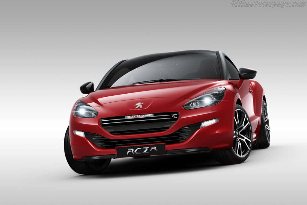 Luxury Red Peugeot Rcz Against Quaint Countryside Backdrop Wallpaper